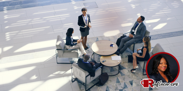 A professional group meeting in a circle, Erica Reed’s headshot overlayed in the bottom right