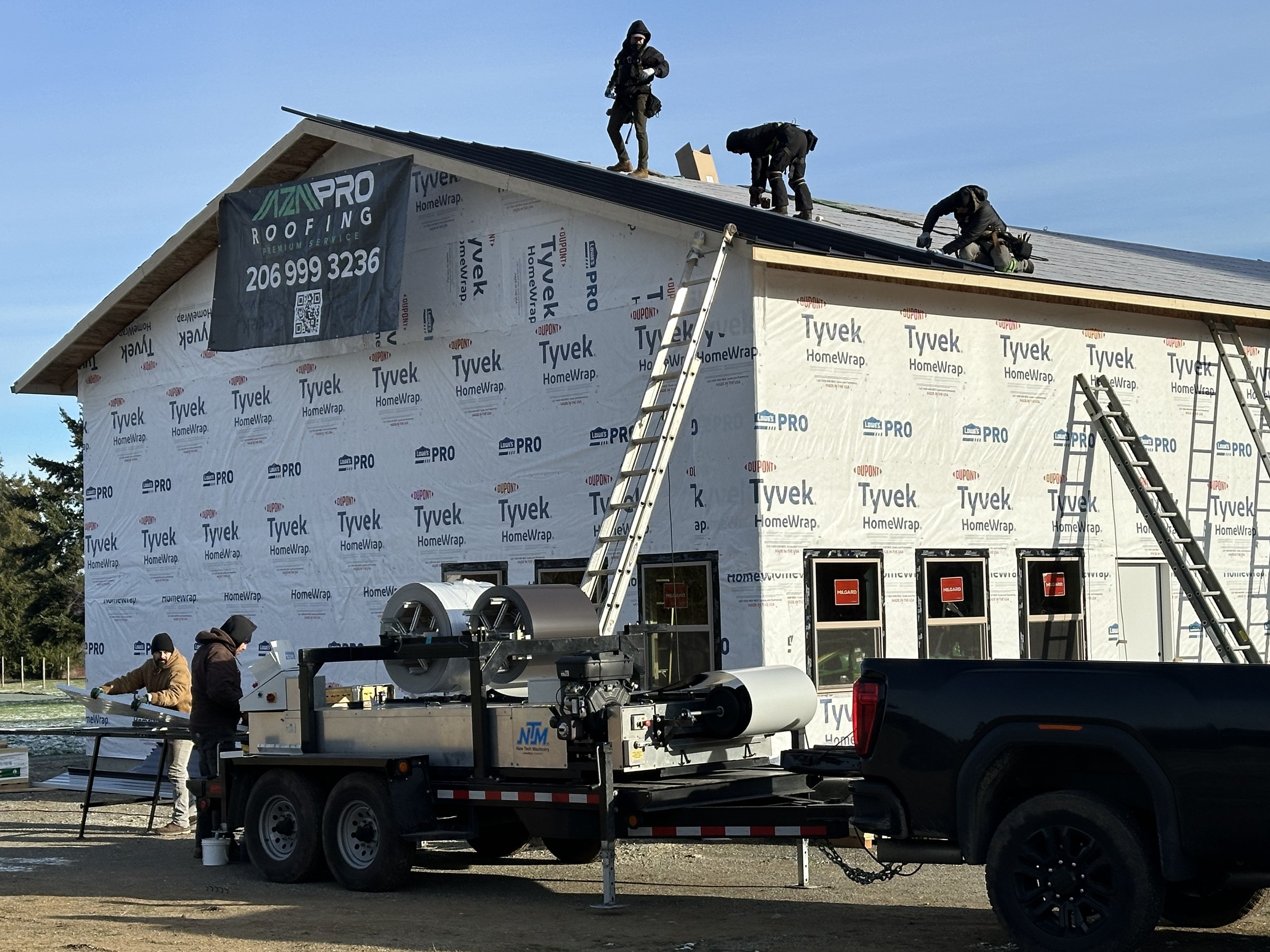 Our crew fabricating standing seam panels on site with our New Tech Machinery roll former
